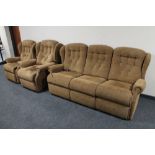 A three piece lounge suite in brown floral fabric