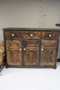 A stained pine triple door sideboard fitted with three drawers CONDITION REPORT: