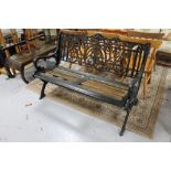 An antique cast iron wooden slatted garden bench 131 cm wide. 72 cm depth and 82.5 cm height.