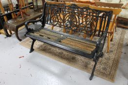 An antique cast iron wooden slatted garden bench 131 cm wide. 72 cm depth and 82.5 cm height.