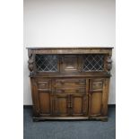 A carved oak court cupboard