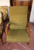 A mid century teak framed high backed armchair