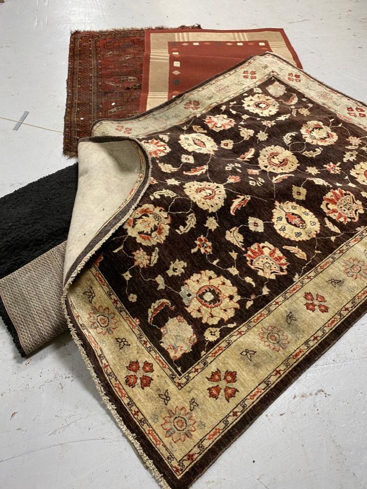 A Persian geometric design rug on red ground (a/f) together with three further rugs