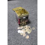 A metal tin of pre decimal British coins and foreign coins