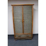 A bamboo and wicker double door wardrobe, width 110 cm, height 194 cm.
