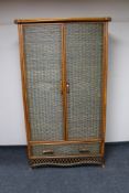 A bamboo and wicker double door wardrobe, width 110 cm, height 194 cm.