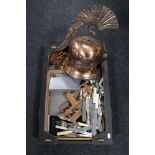 A box of copper Gladiator style helmet, carved wooden animal figures,
