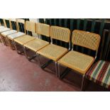 A set of four contemporary kitchen chairs on tubular metal legs