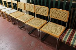 A set of four contemporary kitchen chairs on tubular metal legs