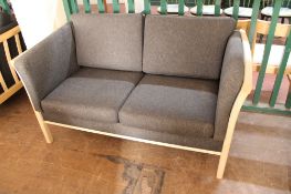 A contemporary wooden framed settee in charcoal fabric CONDITION REPORT: 143cm long