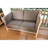 A contemporary wooden framed settee in charcoal fabric CONDITION REPORT: 143cm long