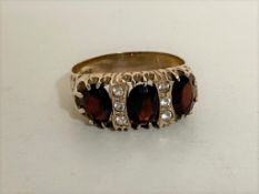 A 9ct gold garnet and CZ ring,