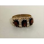 A 9ct gold garnet and CZ ring,