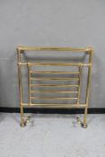 A brass heated towel rail CONDITION REPORT: 81 cm wide x 93.5 cm height.