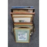 A luggage case containing framed pictures and prints