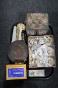 A tray of oriental pieces, boxed miniature tea service, hundred year calendar, jewellery basket,