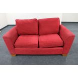 A Marks and Spencer two seater settee in red fabric