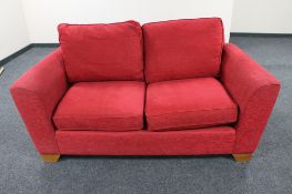 A Marks and Spencer two seater settee in red fabric