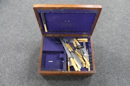 An Edwardian oak cutlery canteen containing cutlery,