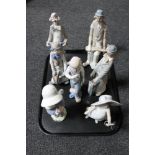 A tray containing two Nao figures of a girl with hand mirror, girl with flower,
