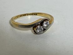 An 18ct gold two-stone diamond crossover ring, size N CONDITION REPORT: 2.