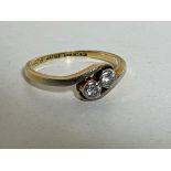 An 18ct gold two-stone diamond crossover ring, size N CONDITION REPORT: 2.