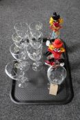 A tray of a set of eight wine glasses together with two Murano glass clowns