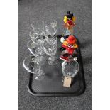 A tray of a set of eight wine glasses together with two Murano glass clowns