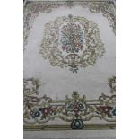 An Indian floral fringed carpet on cream ground CONDITION REPORT: 275 cm x 367 cm.