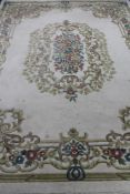 An Indian floral fringed carpet on cream ground CONDITION REPORT: 275 cm x 367 cm.