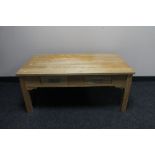 A contemporary pine coffee table fitted with two drawers