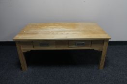 A contemporary pine coffee table fitted with two drawers