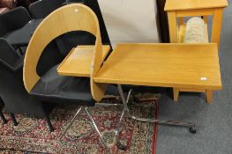 A chrome based reading table together with a swivel chair