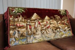 An Eastern chenille fringed tapestry depicting pyramids and camels