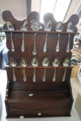 A Georgian style oak spoon rack with spoons