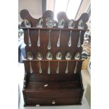 A Georgian style oak spoon rack with spoons