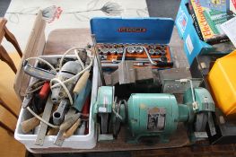 An industrial electric table grinder, a box of tools,