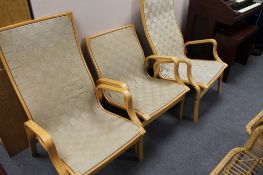 A set of three mid century beech armchairs