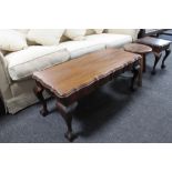 A mahogany coffee table together with a lamp table and a stool