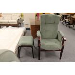 A stained beech framed adjustable armchair and footstool in green fabric