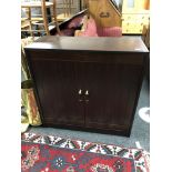 A reproduction mahogany double door cabinet