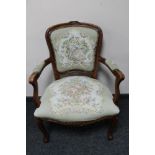 A continental beech framed armchair in tapestry fabric