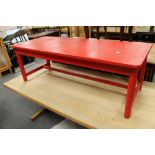 A painted red coffee table together with a further teak coffee table