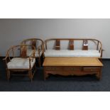 An Oriental style three piece lounge suite comprising four seater settee,