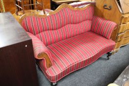 A nineteenth century walnut framed striped settee