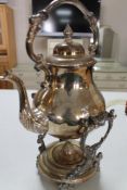 A silver plated spirit kettle on stand