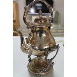 A silver plated spirit kettle on stand