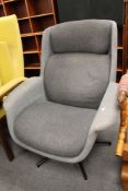 A grey fabric swivel contemporary chair