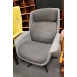 A grey fabric swivel contemporary chair