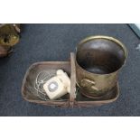 A brass coal helmet together with a vintage trug and an old telephone